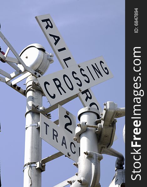 Looking up at railroad crossing sign for two track line.