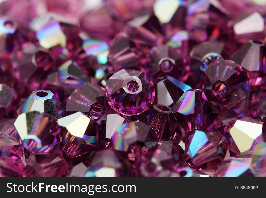 Close up of a pile of dark purple beads.