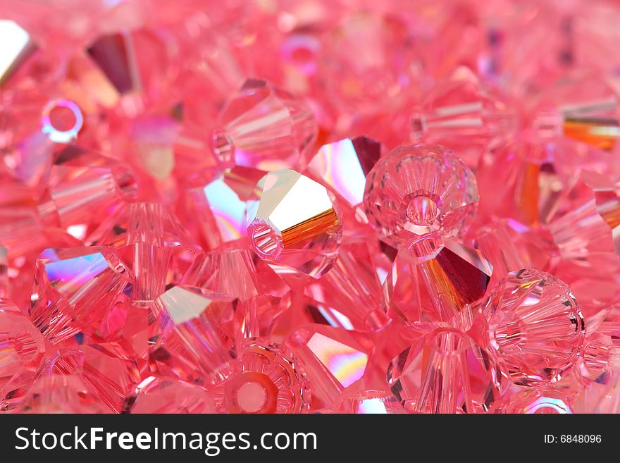 Close up of a pile of pink and shiny beads. . Close up of a pile of pink and shiny beads.