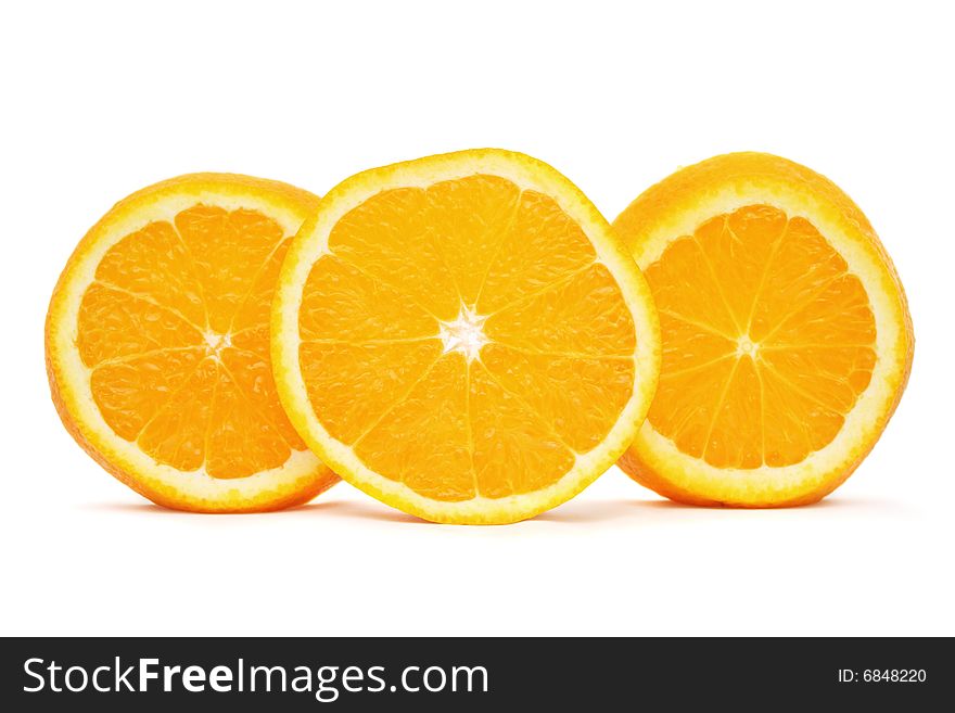 Orange sliced into three pieces standing on white background. Orange sliced into three pieces standing on white background.