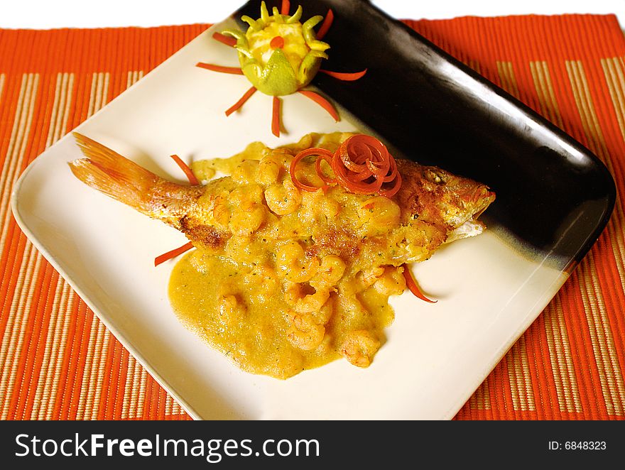 Whole red snapper served with a shrimp sauce