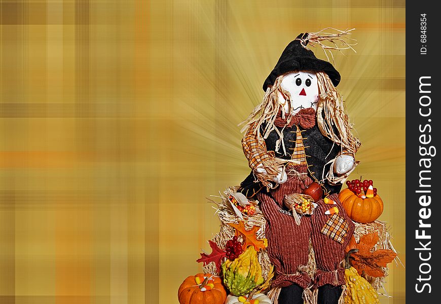 A scarecrow on a country hay bale with a plaid background. A scarecrow on a country hay bale with a plaid background.