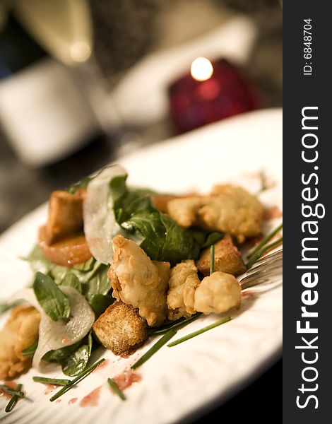 Fried Malpeque Oysters served with baby arugula, shaved fennel, blood orange vinaigrette, and cumin scented croutons