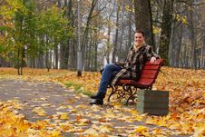 Young Woman Sitting On A Bench Royalty Free Stock Photo