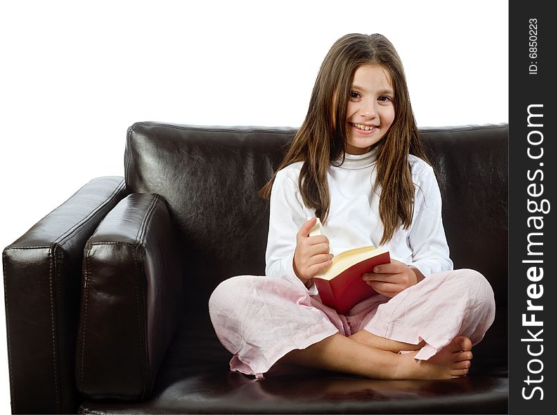 Girl reading a book on a sofa isolated on white