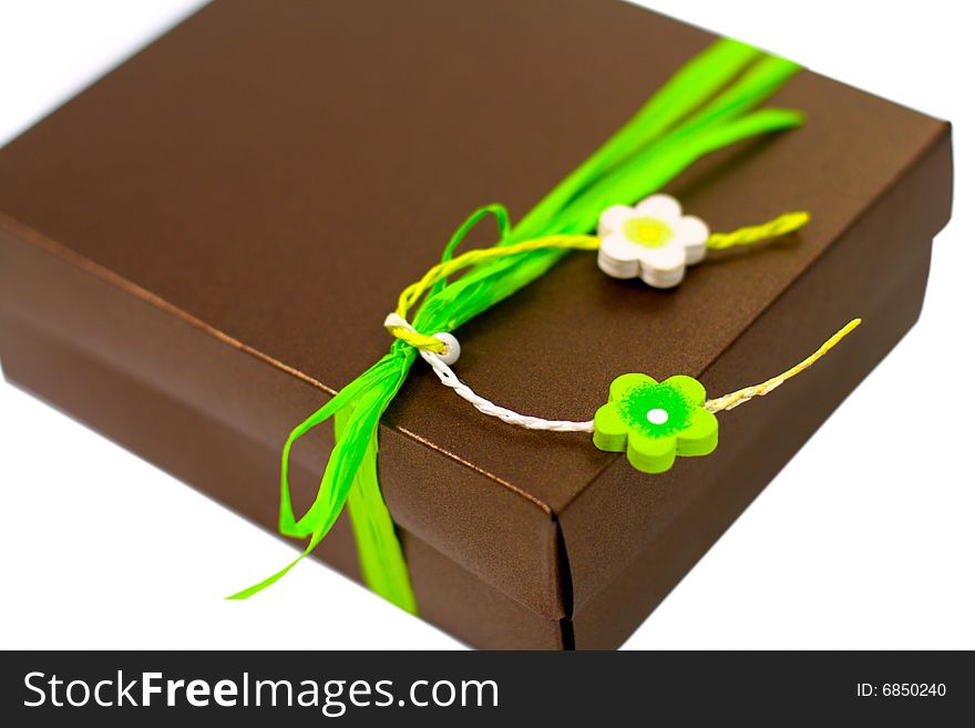 Brown gift box with green decoration closeup