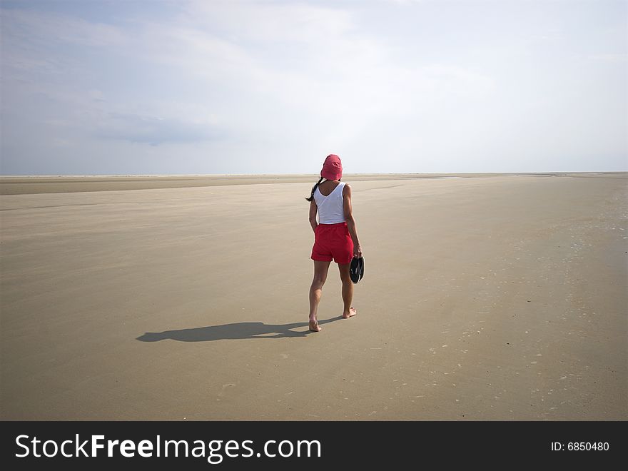 Walking in the Sun. Woman walking on Koresand, Low Tide Island in Denmark