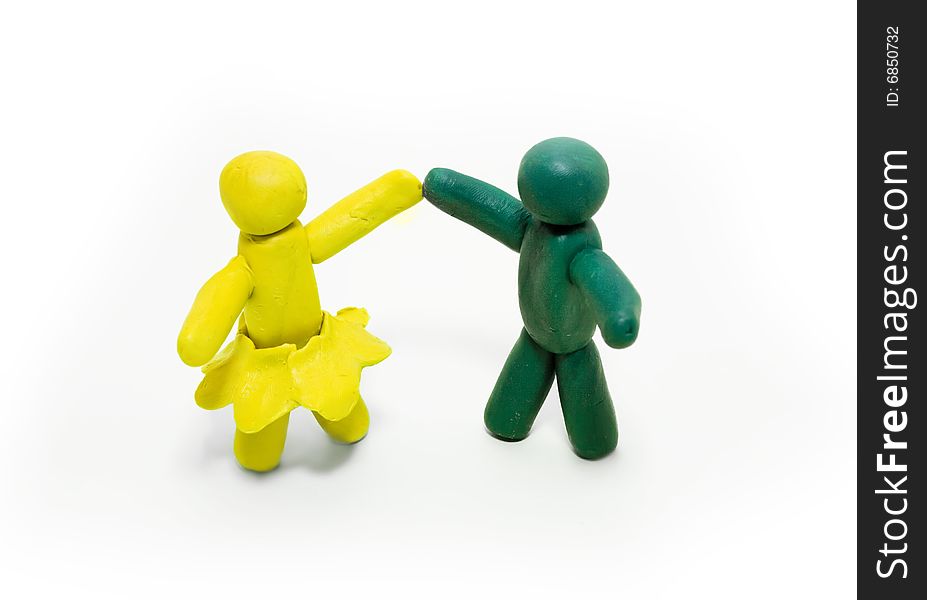 Two clay figures dancing on white background