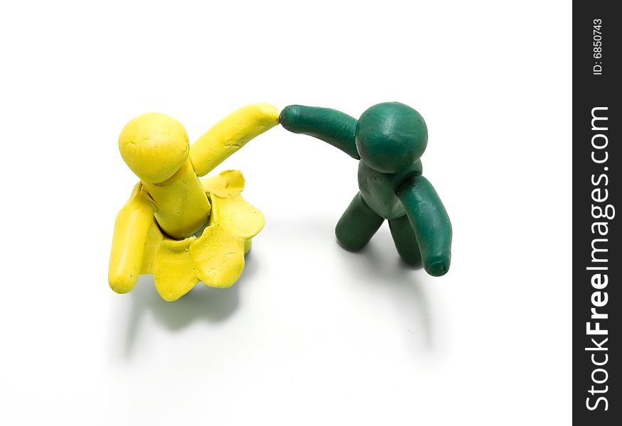 Two clay figures dancing on white background