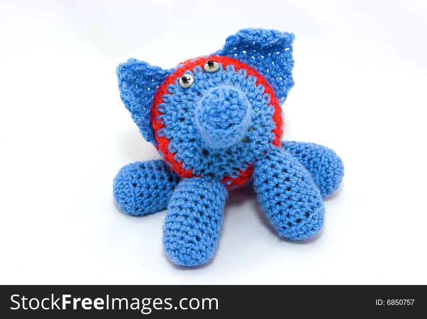 Knitted blue elephant with red stripes. Knitted blue elephant with red stripes