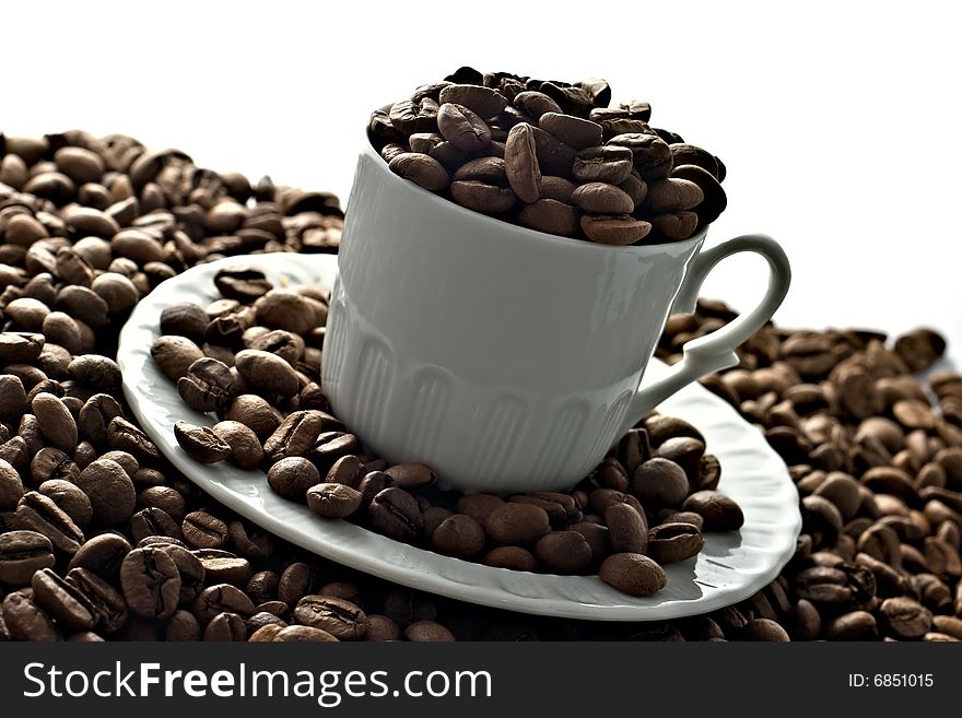 A cup of coffee beans isolated on white