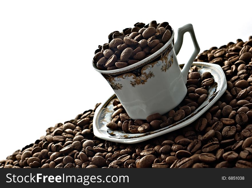 Traditional Turkish Coffee in ornamented traditional cup on a pile of coffee beans.