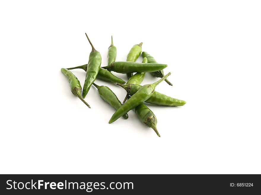 Green chilis on a white background