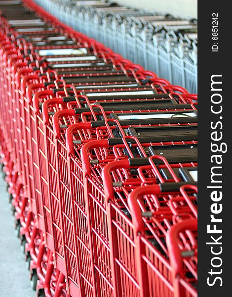 Row of red metal shopping carts