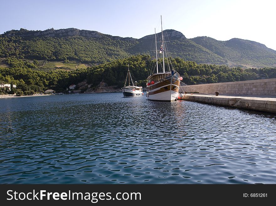 Two vintage, wooden ships in the small port. Two vintage, wooden ships in the small port