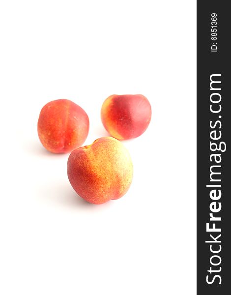 Three peaches isolated on white