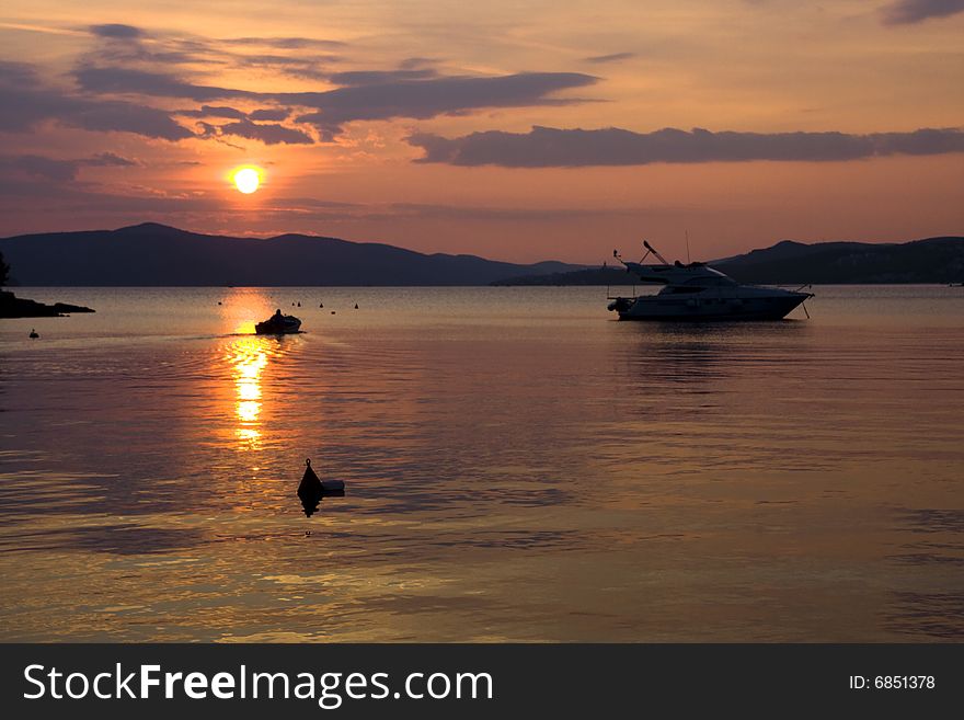 Sunset at the small bay against a background of mountains. Sunset at the small bay against a background of mountains