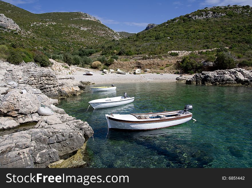 Fishing boats in the small, rocky bay. Fishing boats in the small, rocky bay