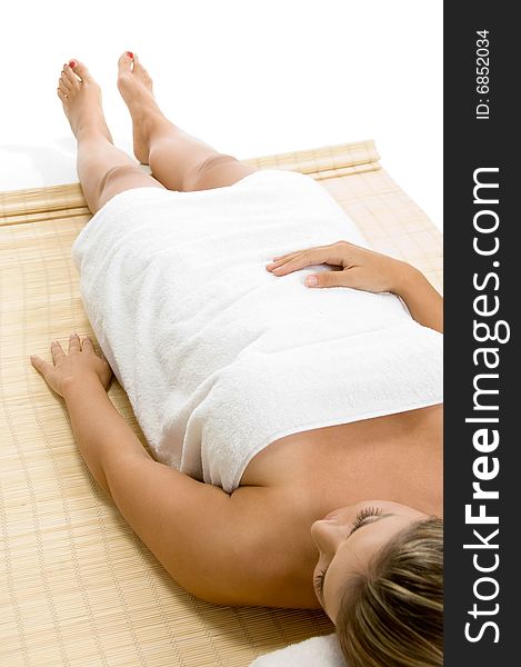 Portrait of laying blonde female on an isolated white background