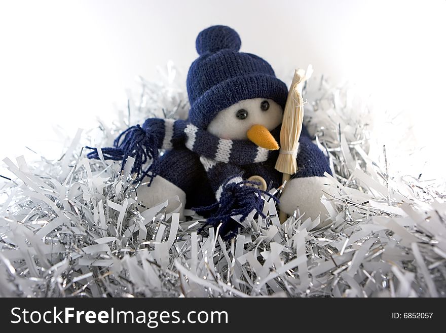 Tailored snowman sitting in tinsels. Tailored snowman sitting in tinsels