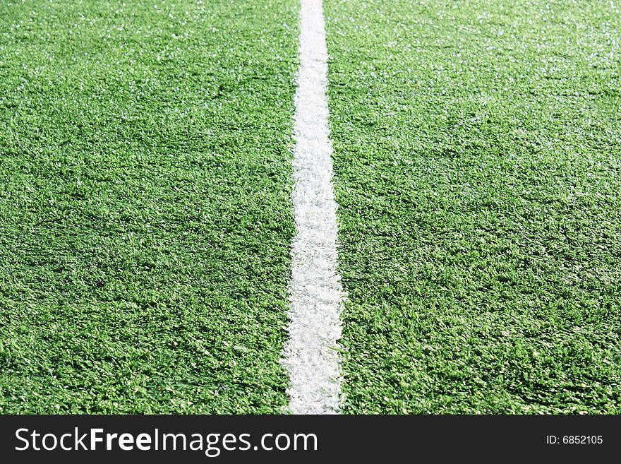 White stripe on an artificial grass of stadium. White stripe on an artificial grass of stadium