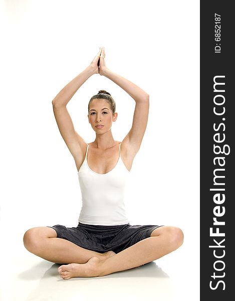 Young woman doing yoga on an isolated white background