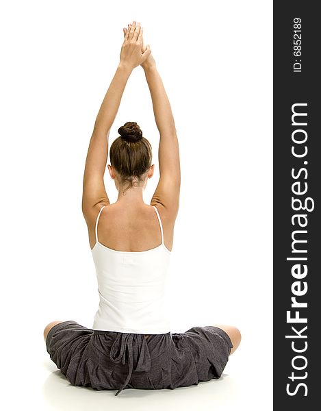 Young woman doing yoga on an isolated background