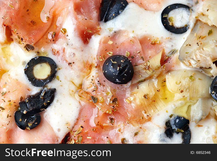 Extreme closeup of italian pizza with bacon and artichokes