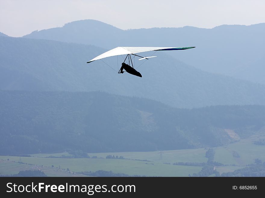 Man with flying wing on sky