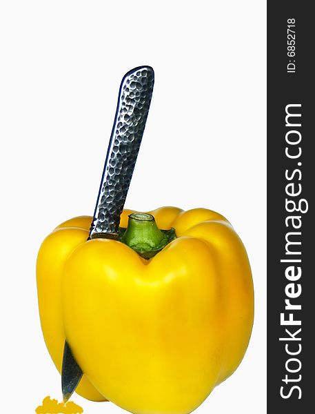 Yellow capsicum pepper with knife