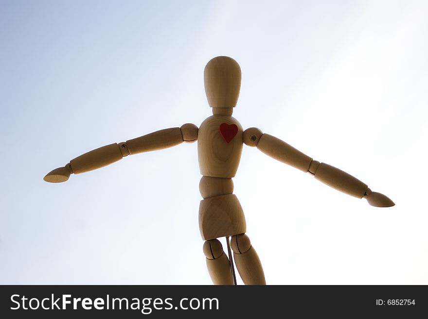 Wooden dummy against the sky