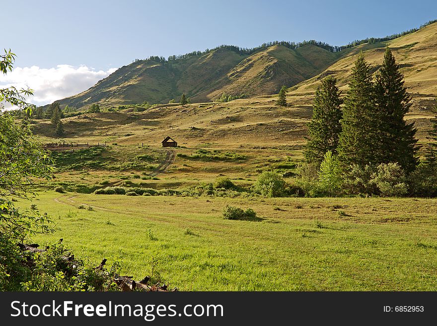 Wood house with cattle-pen in mountains. Wood house with cattle-pen in mountains
