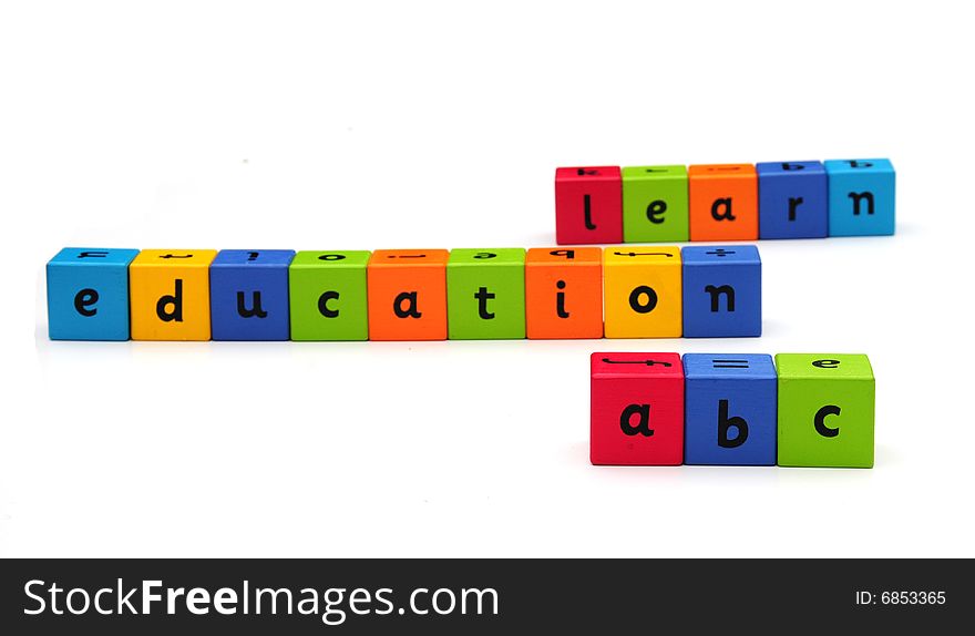 Colorful bricks spelling out words on white