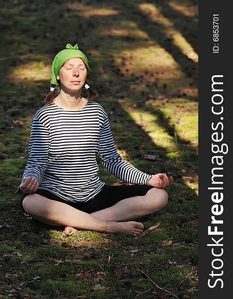 The woman meditates in wood