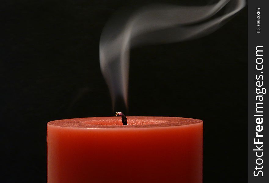 Candle with smoke on the black background
