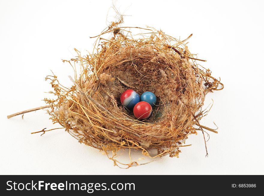 Three marbles in a little bird's nest of twigs. Three marbles in a little bird's nest of twigs