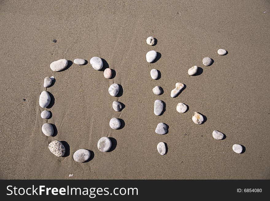 OK inscription on the sand