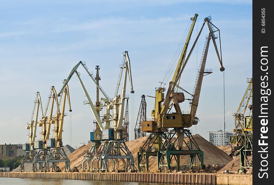 Port on river with cargo cranes. Port on river with cargo cranes