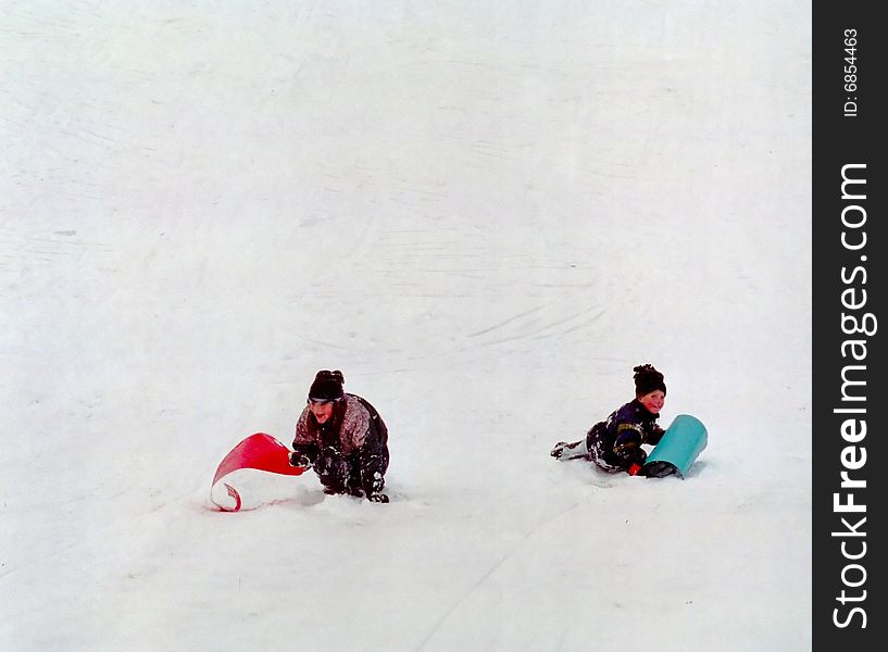 Brother and sister enjoy a day snow sledding. Brother and sister enjoy a day snow sledding.