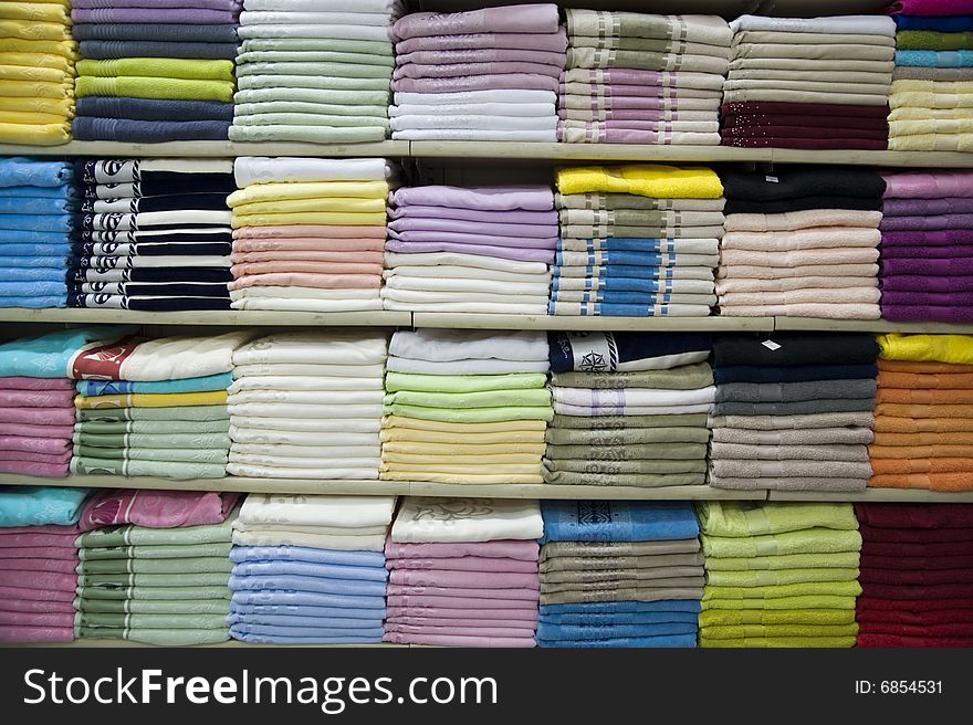 Many Turkish towels on shelfs of shop