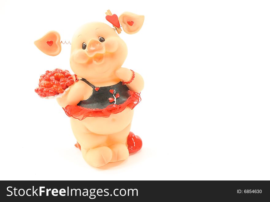 Against the background stands pig in a beautiful red dress with a bouquet of flowers