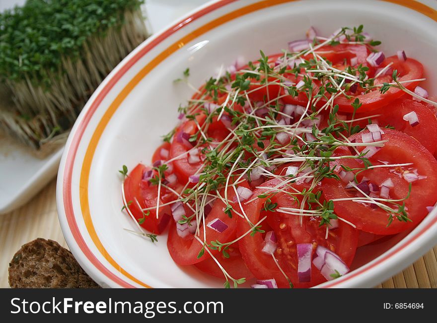 A fresh salad of tomatoes with sprouts