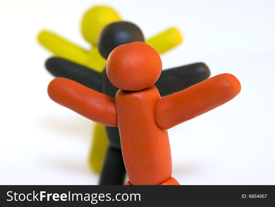 Three plasticine men standing isolated on white background