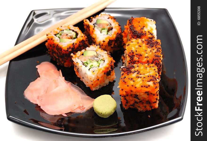 Sushi rolls over black plate