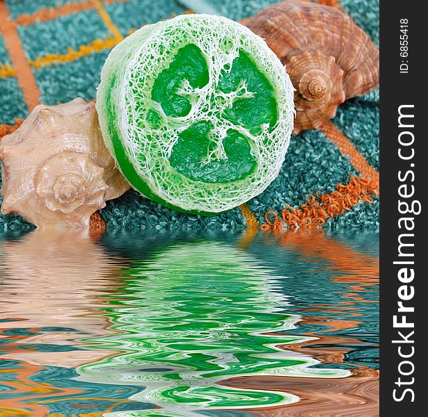 Spa concept - special gren soap and shells over towel. Spa concept - special gren soap and shells over towel