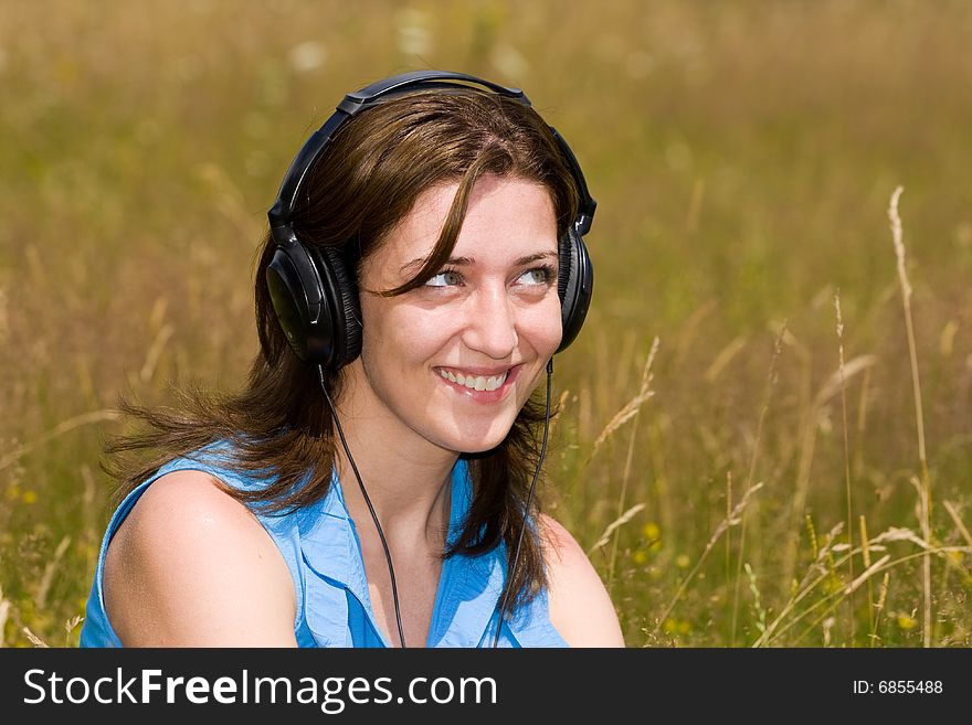 Attractive Young Woman Listening Music Outdoors