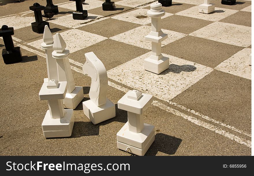Chessmen on a giant chess table