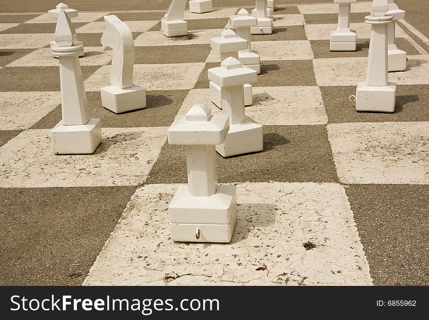 Chessmen on a giant chess table