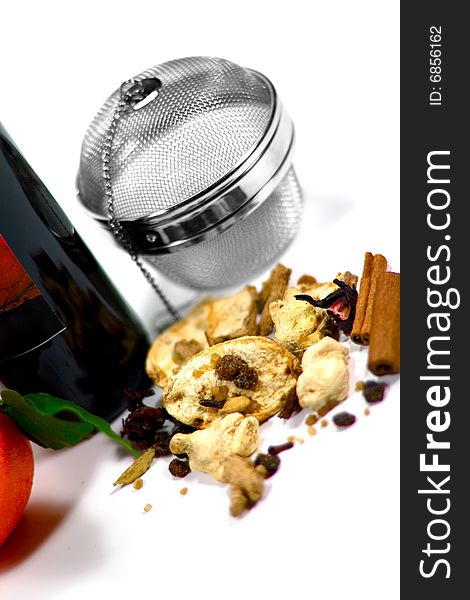 Wine, dried fruits, spices and metal strainer on white background