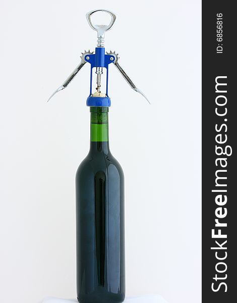 Red  wine bottle with corkscrew isolated on white background. Red  wine bottle with corkscrew isolated on white background